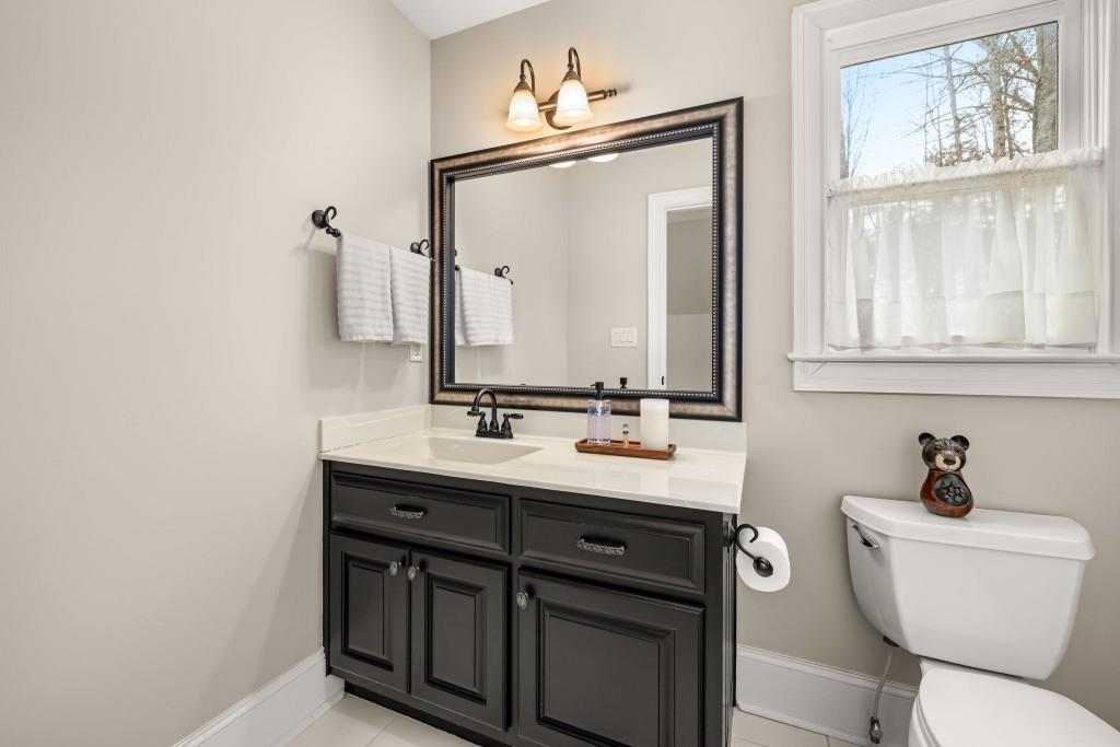 99 Madeline Anthony Road Dahlonega, GA 30533 - Photo 44 of 60 a bathroom with a toilet sink and mirror