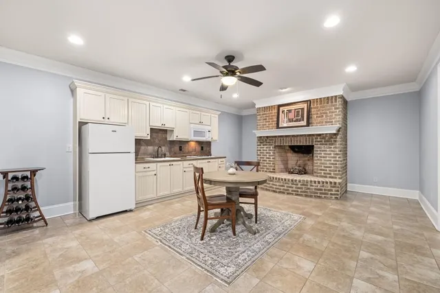 a view of a patio with table and chairs a barbeque with wooden fence