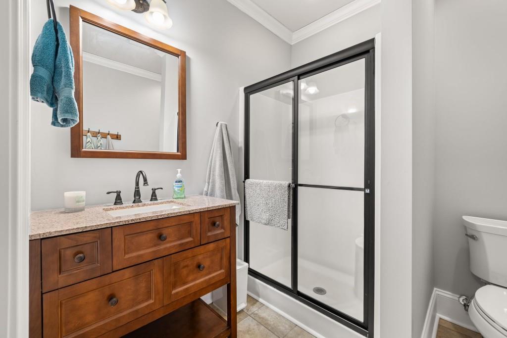 99 Madeline Anthony Road Dahlonega, GA 30533 - Photo 52 of 60 a bathroom with a granite countertop sink toilet and mirror