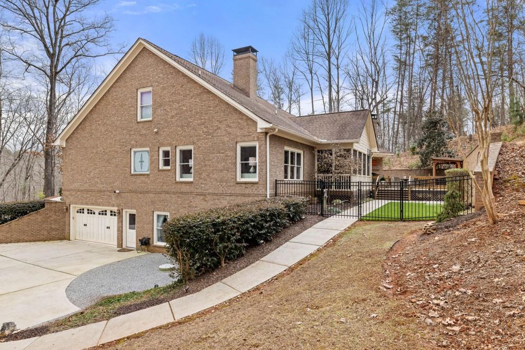 99 Madeline Anthony Road Dahlonega, GA 30533 - Photo 55 of 60 a front view of a house with a yard and garage