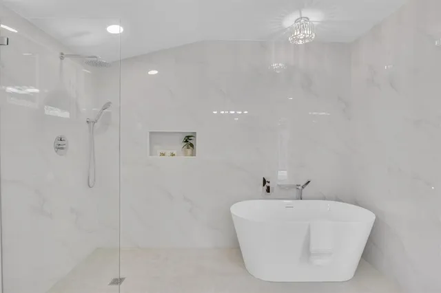 a spacious bathroom with a granite countertop sink a toilet and a mirror