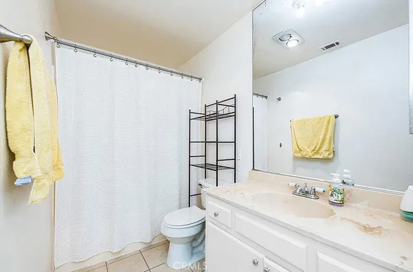 a bathroom with a sink vanity mirror and toilet