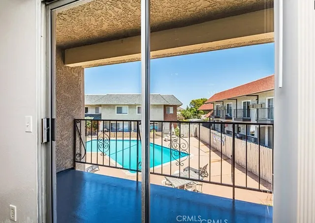 a view of a swimming pool with potted plants