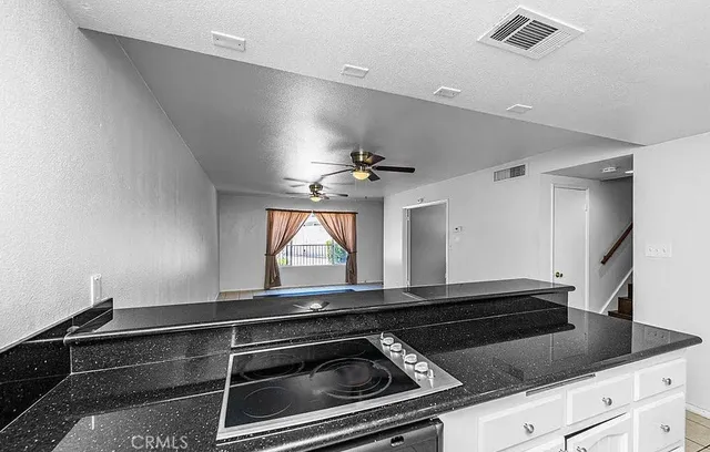 a kitchen with a refrigerator a stove and a cabinets