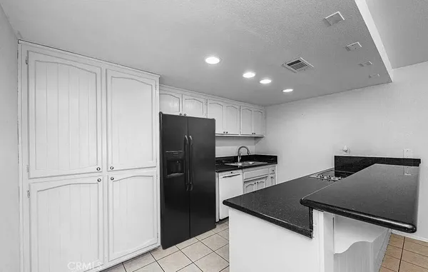 a kitchen with a refrigerator a stove and a cabinets