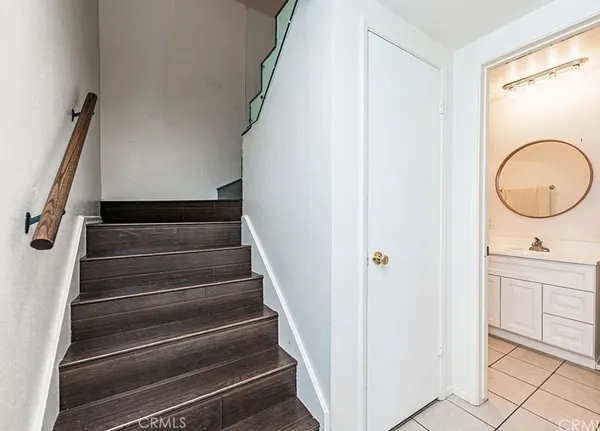 a view of staircase with white walls and a window