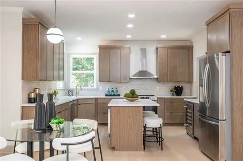 a kitchen with a sink stove and refrigerator
