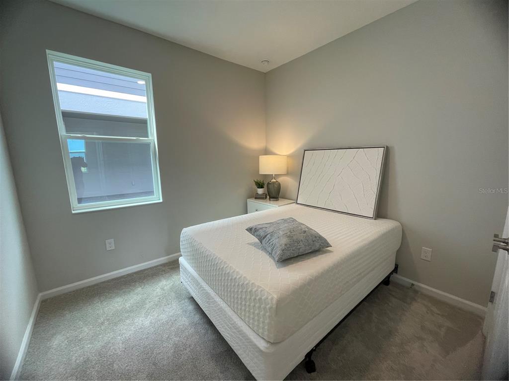 5288 Ctr Lk Rnch Boulevard St. Cloud, FL 34771 - Photo 11 of 31 a bedroom with a bed and a night stand