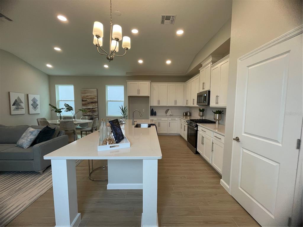 5288 Ctr Lk Rnch Boulevard St. Cloud, FL 34771 - Photo 14 of 31 a kitchen with counter top space a sink cabinets and appliances