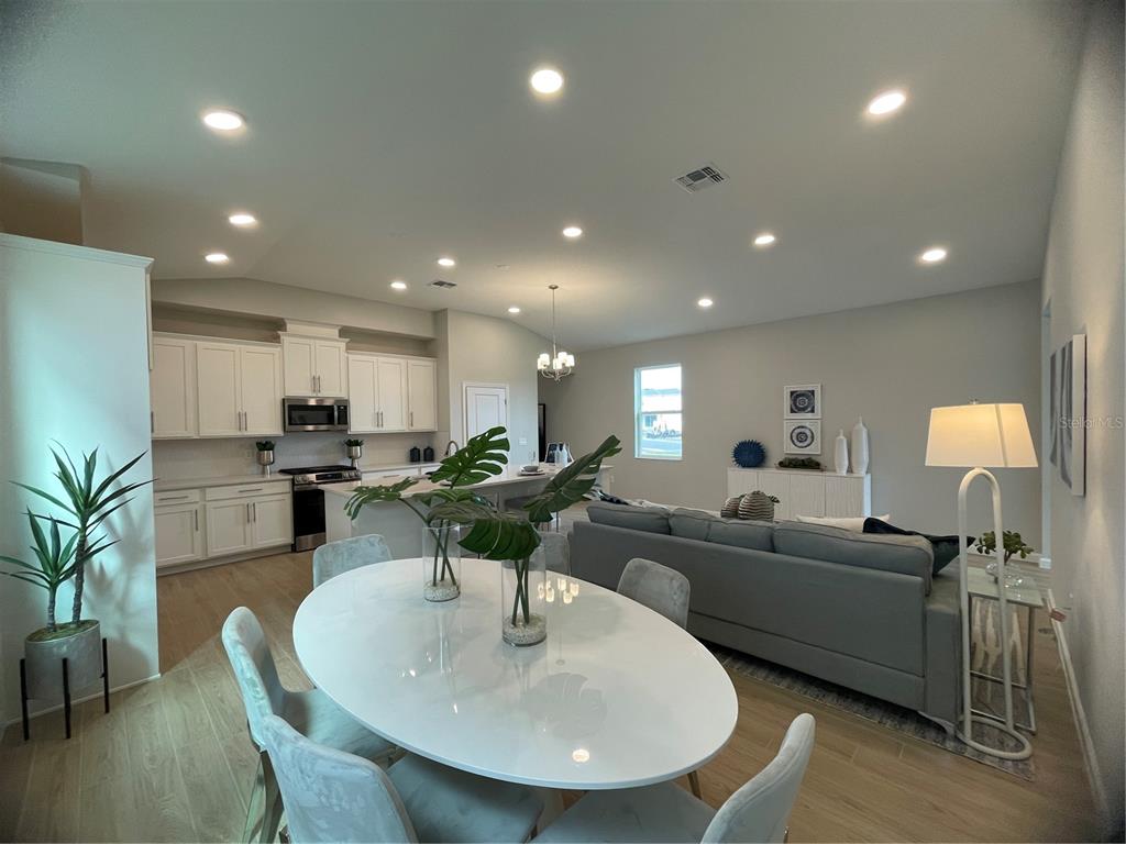 5288 Ctr Lk Rnch Boulevard St. Cloud, FL 34771 - Photo 17 of 31 a living room with furniture kitchen view and a potted plant