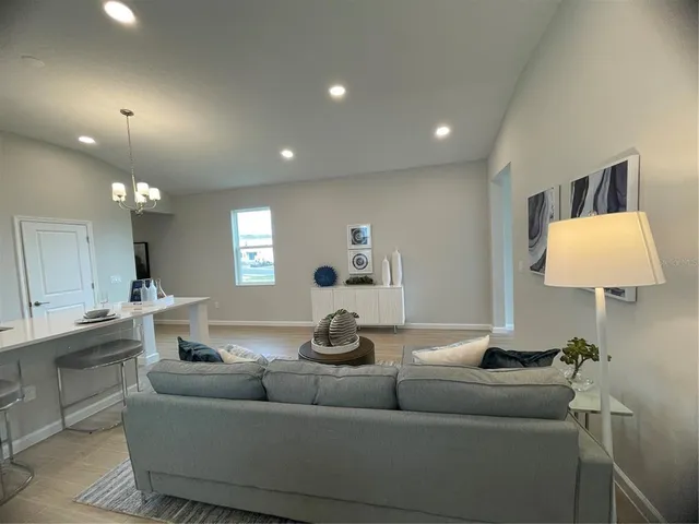 a living room with furniture and a lamp