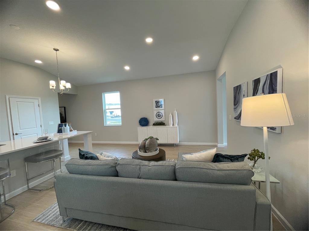 5288 Ctr Lk Rnch Boulevard St. Cloud, FL 34771 - Photo 18 of 31 a living room with furniture and a lamp