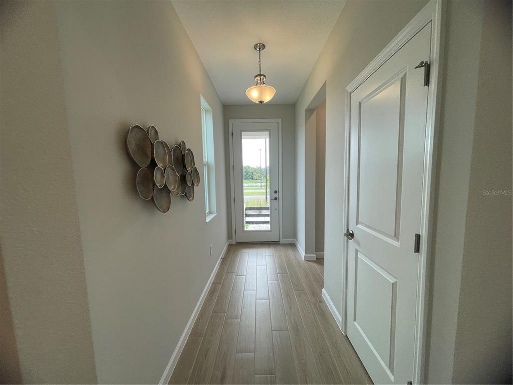 5288 Ctr Lk Rnch Boulevard St. Cloud, FL 34771 - Photo 23 of 31 a view of a hallway with wooden floor and closet