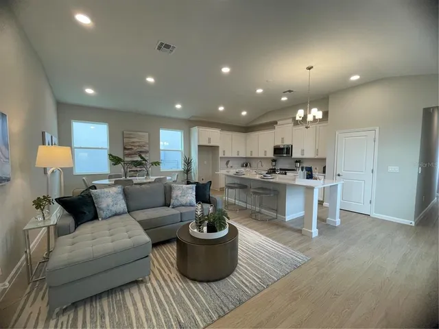a living room with furniture and kitchen view