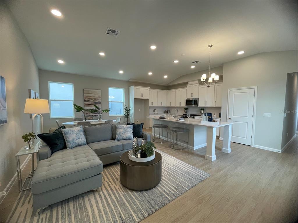 5288 Ctr Lk Rnch Boulevard St. Cloud, FL 34771 - Photo 29 of 31 a living room with furniture and kitchen view