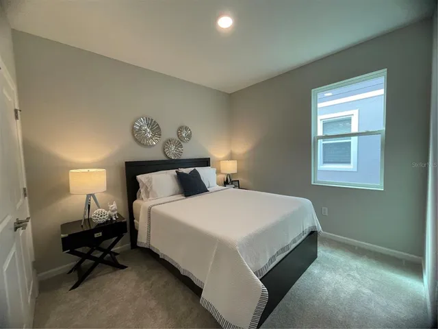 a bedroom with a bed and a window