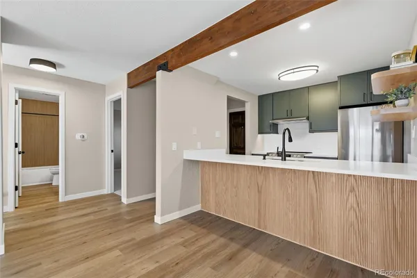 a kitchen with stainless steel appliances a sink and refrigerator