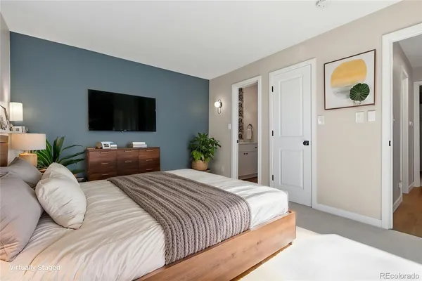a bedroom with a bed and a television