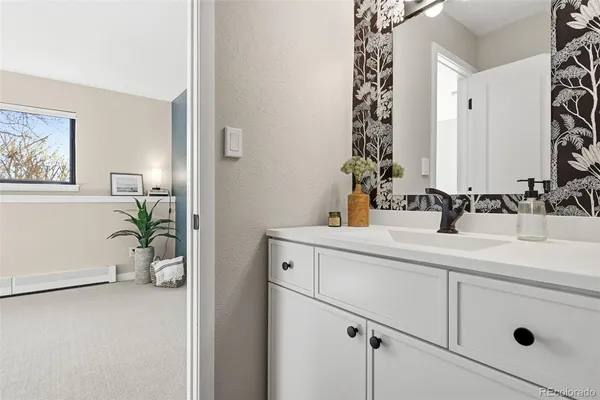 a bathroom with a sink a mirror and a shower