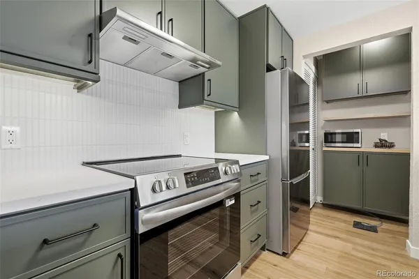 a stove top oven sitting inside of a kitchen