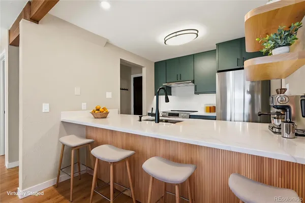 a kitchen with stainless steel appliances a sink and a refrigerator