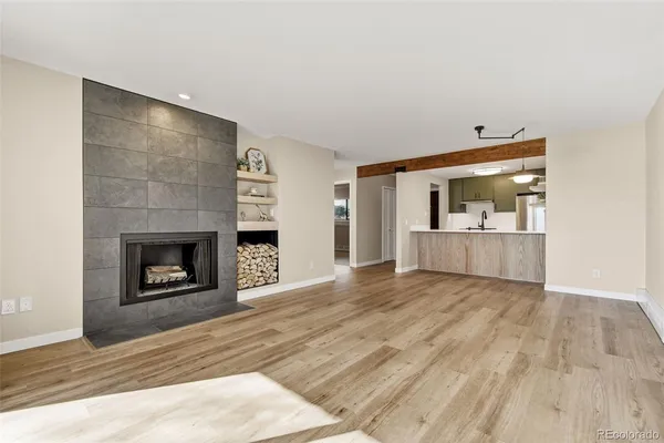 a living room with a fireplace and a wooden floor