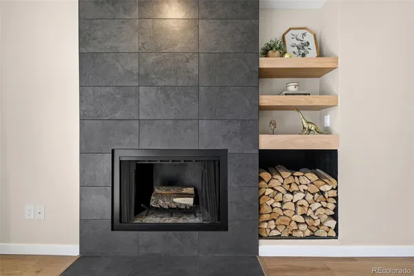 a room with a fireplace and a painting on the wall