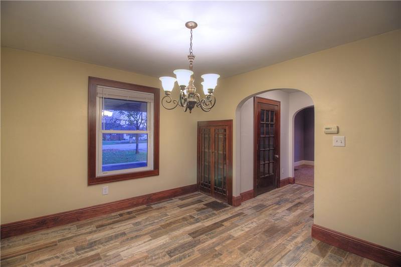 2248 Mercer Road New Brighton, PA 15066 - Photo 4 of 25 You are looking from the dining area into the front Entry. Note the updated flooring, light fixtures that complement the original wood built-ins & 15-panel glass door.
