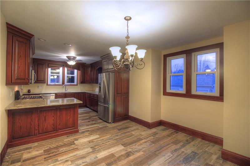 2248 Mercer Road New Brighton, PA 15066 - Photo 5 of 25 Stunning open Dining Room/Kitchen combo. Note the quality Amish solid wood cabinets, expanisve granite countertops and eating area!