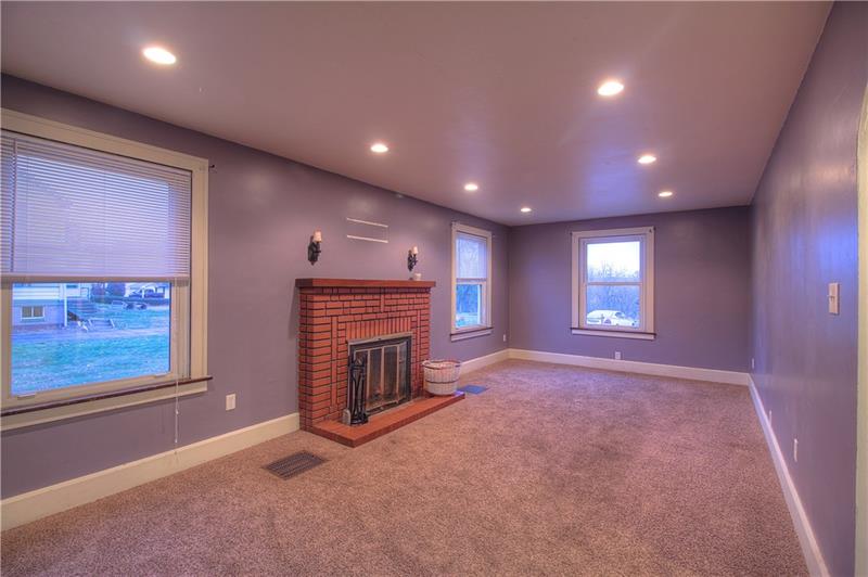 2248 Mercer Road New Brighton, PA 15066 - Photo 9 of 25 More spacious than it appears, the living room expands the full length of the home. The decorative fireplace is a focal point!