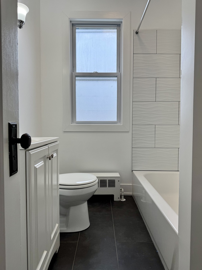 2125 Wesley Avenue, Unit 2 Berwyn, IL 60402 - Photo 15 of 26 a bathroom with a sink a toilet and shower