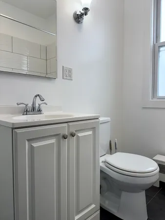 a bathroom with a sink a toilet and vanity