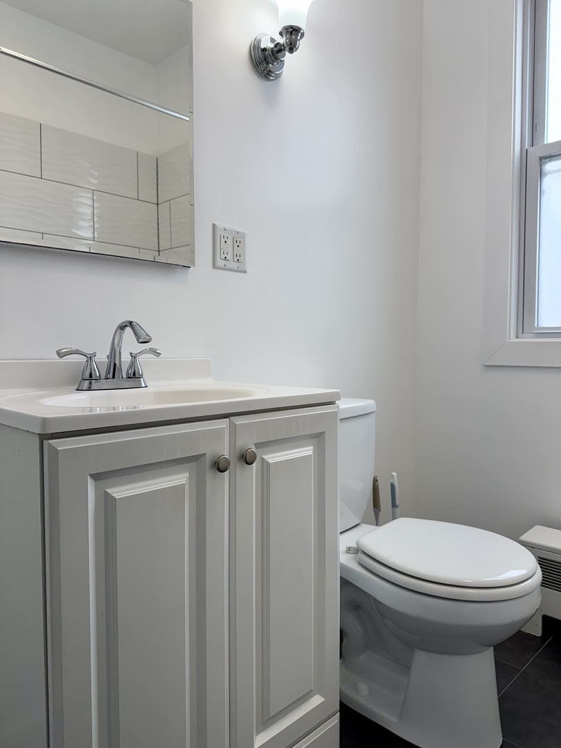 2125 Wesley Avenue, Unit 2 Berwyn, IL 60402 - Photo 17 of 26 a bathroom with a sink a toilet and vanity