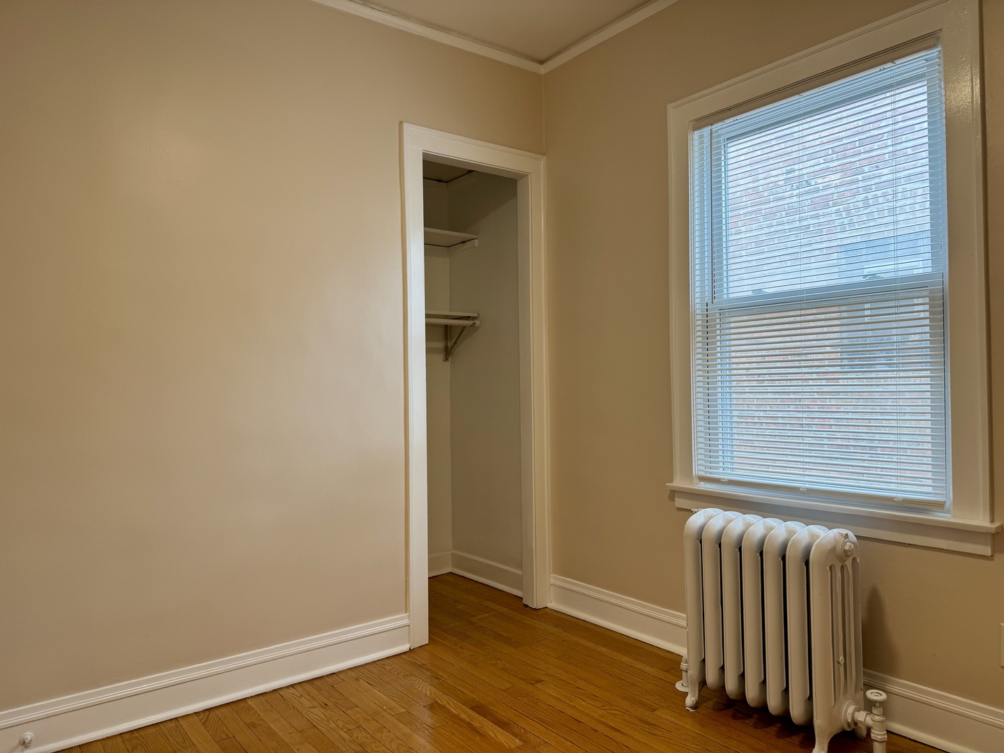 2125 Wesley Avenue, Unit 2 Berwyn, IL 60402 - Photo 19 of 26 a view of an empty room with wooden floor and a window