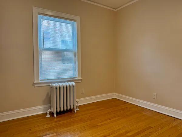 a view of a livingroom with wooden floor and a window
