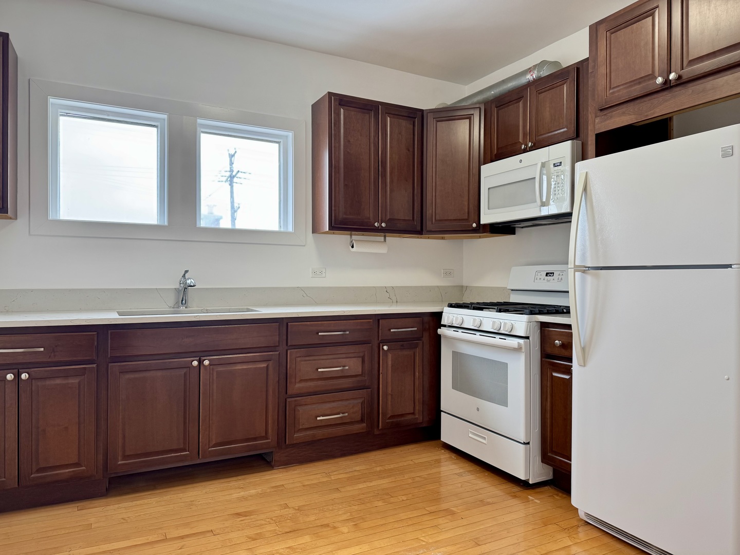 2125 Wesley Avenue, Unit 2 Berwyn, IL 60402 - Photo 22 of 26 a kitchen with stainless steel appliances granite countertop a sink a stove a refrigerator and cabinets