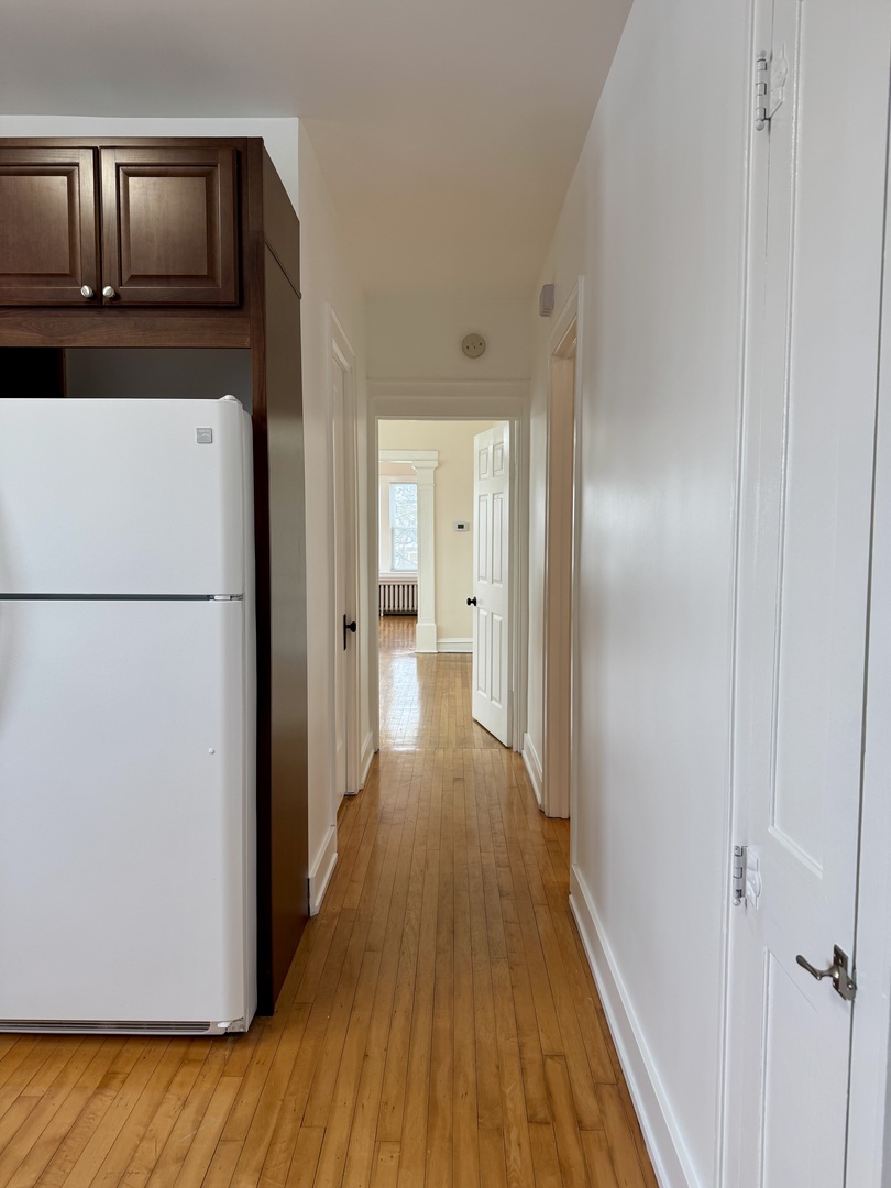 2125 Wesley Avenue, Unit 2 Berwyn, IL 60402 - Photo 25 of 26 a view of a hallway with wooden floor and cabinets