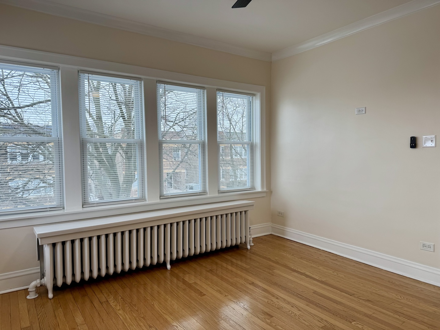 2125 Wesley Avenue, Unit 2 Berwyn, IL 60402 - Photo 3 of 26 a view of an empty room with wooden floor and a window
