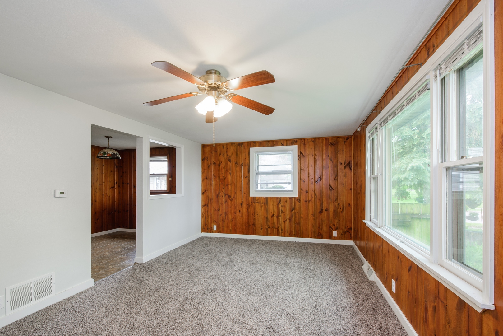 1529 Lewis Street DeKalb, IL 60115 - Photo 2 of 16 an empty room with windows and a chandelier fan