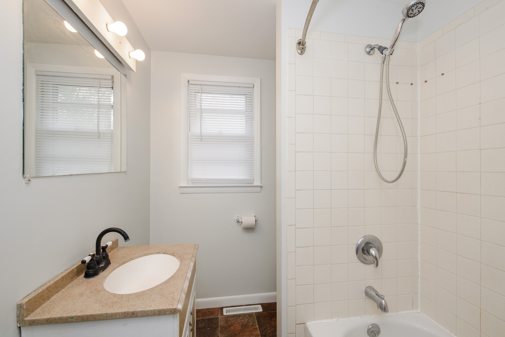 1529 Lewis Street DeKalb, IL 60115 - Photo 14 of 16 a bathroom with a sink vanity mirror and shower
