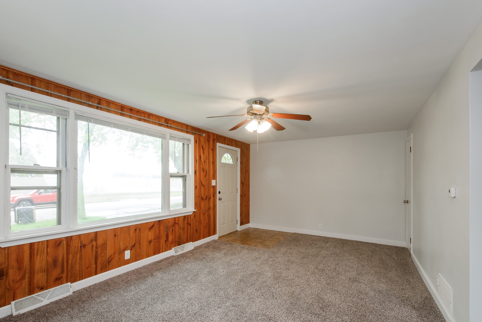 1529 Lewis Street DeKalb, IL 60115 - Photo 3 of 16 a view of an empty room with a window