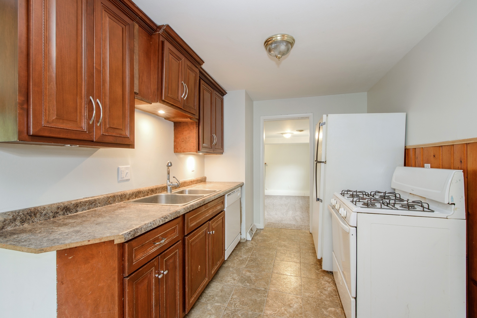 1529 Lewis Street DeKalb, IL 60115 - Photo 4 of 16 a kitchen with granite countertop a sink stove and cabinets