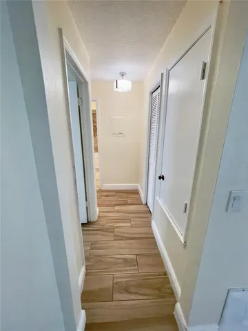 a view of a kitchen with microwave and wooden floor