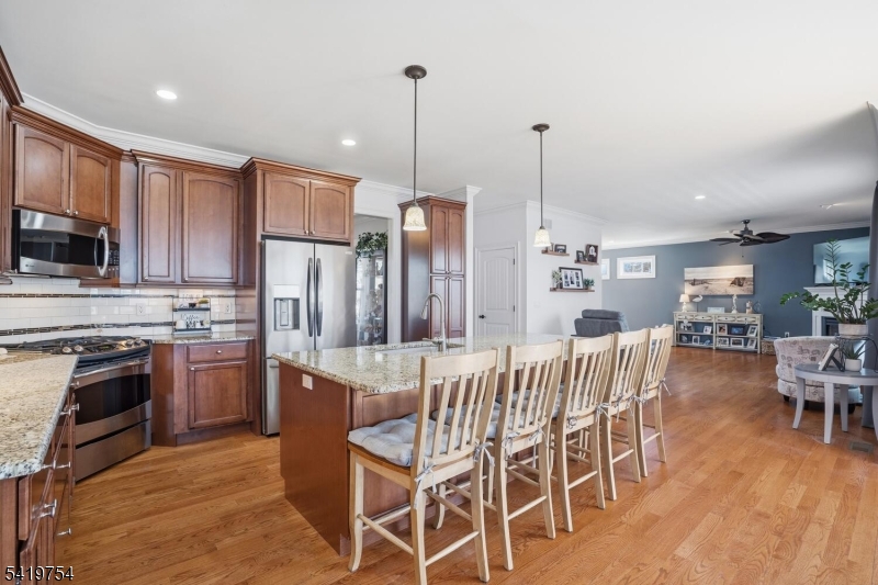 663 Harbor Road Brick, NJ 08724 - Photo 18 of 46 a kitchen with stainless steel appliances kitchen island granite countertop a kitchen island hardwood floor and a sink
