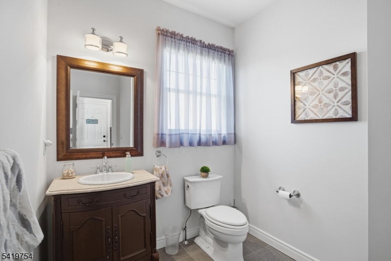 663 Harbor Road Brick, NJ 08724 - Photo 20 of 46 a bathroom with a toilet a sink and mirror