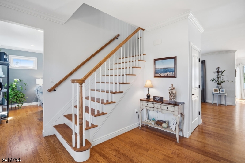 663 Harbor Road Brick, NJ 08724 - Photo 5 of 46 a living room with wooden floor and stairs