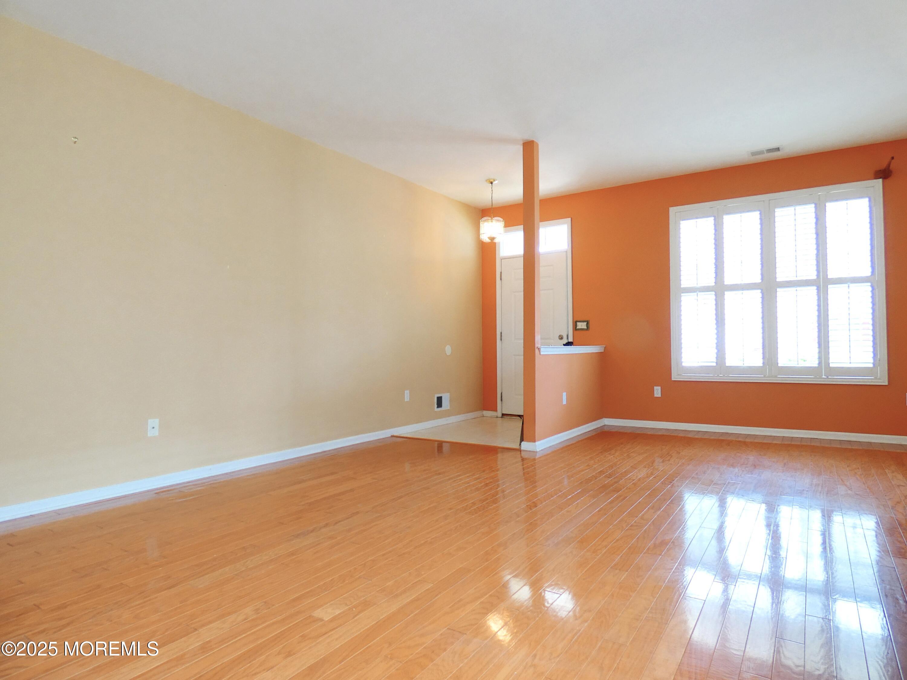 10 Lilly Drive Little Egg Harbor, NJ 08087 - Photo 3 of 28 an empty room with window and wooden floor