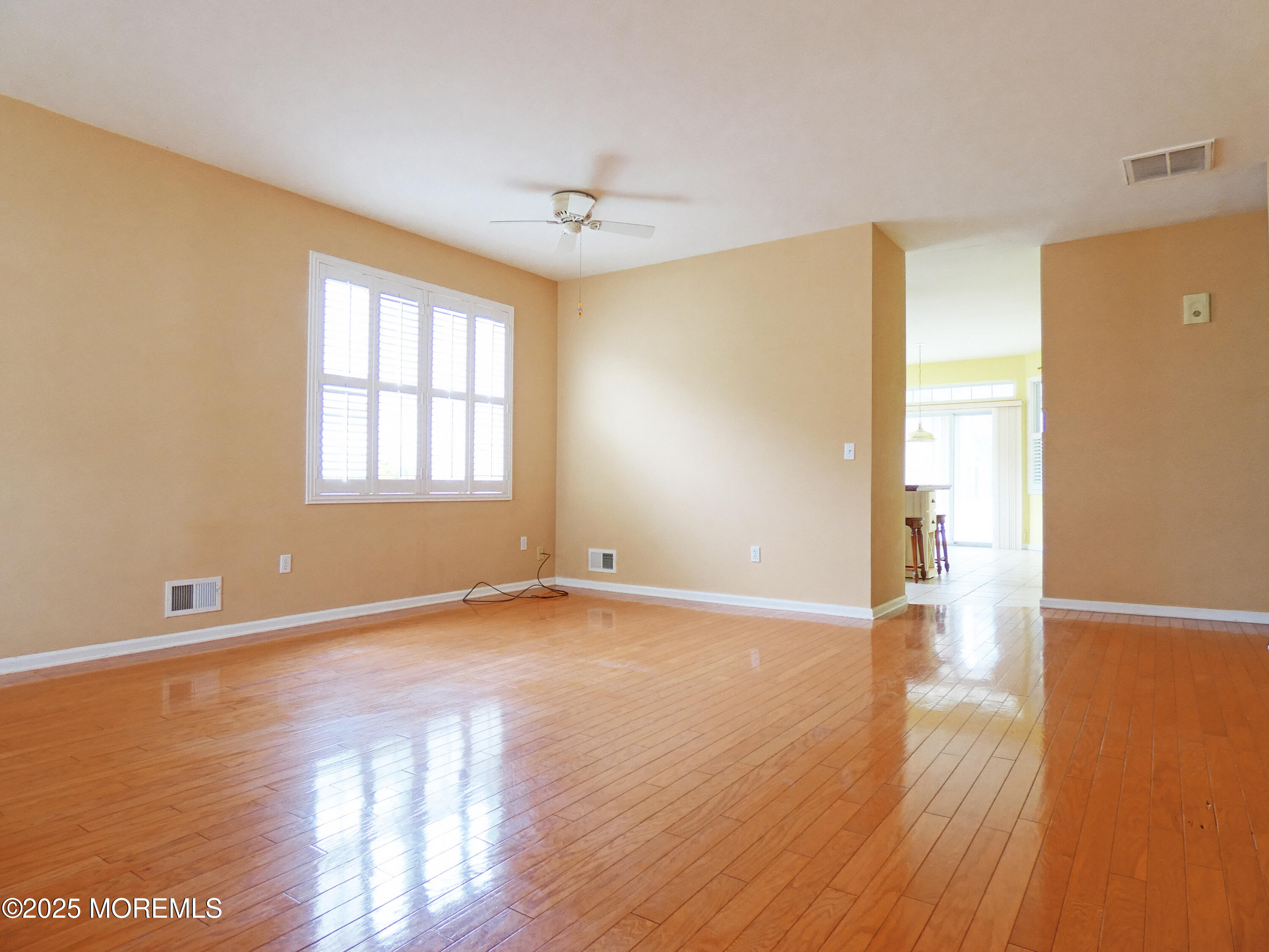 10 Lilly Drive Little Egg Harbor, NJ 08087 - Photo 5 of 28 a view of an empty room with wooden floor and a window