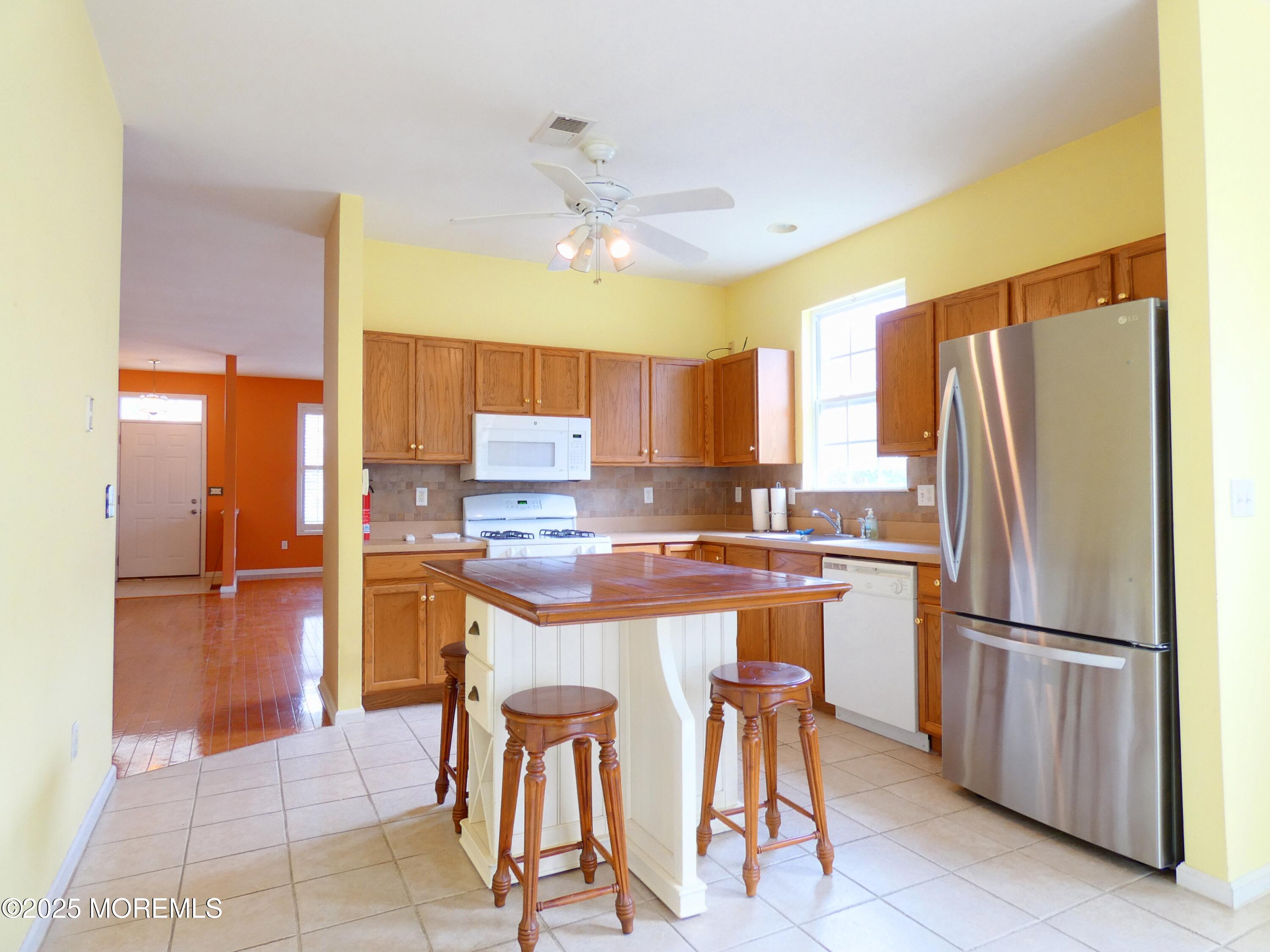 10 Lilly Drive Little Egg Harbor, NJ 08087 - Photo 10 of 28 a kitchen with stainless steel appliances granite countertop a refrigerator a sink dishwasher and a stove with a dining table
