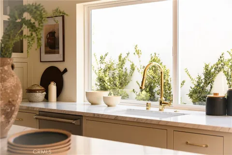 a kitchen with a stove and a wooden floor